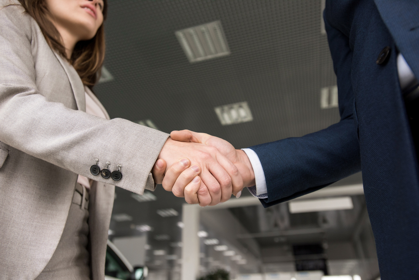 Car Salesman Shaking Hands with Client